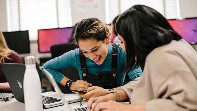 two students laughing together in class