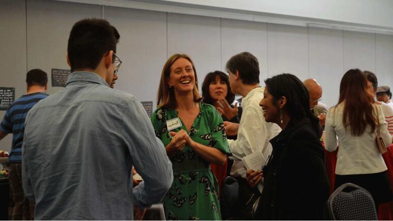 Students discuss in auditorium