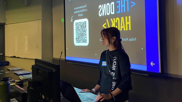 Student presents in front of a projection