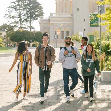 Students walk across campus on a sunny day