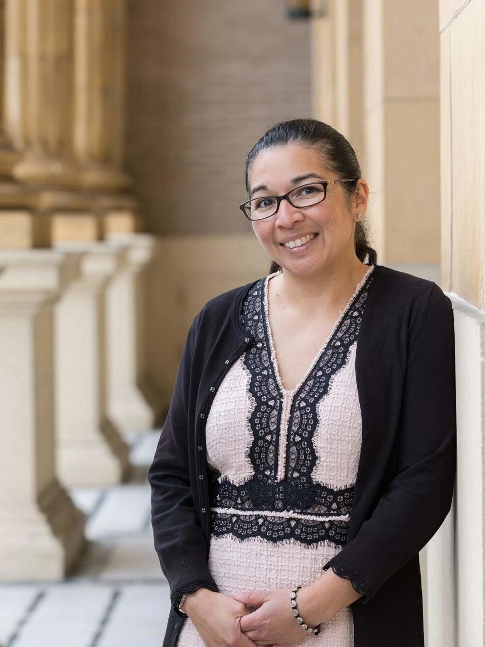 Sonya Arriola stands in front of church and poses for picture